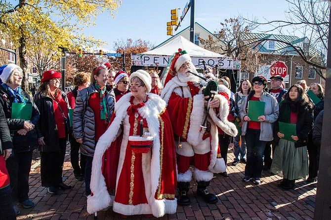 Santa and Ms. Claus with carollers in Old Town for Small Business Saturday.