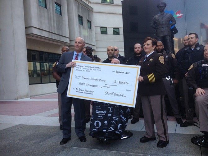 Arlington Sheriff Beth Arthur and Steven Rubloff, president of the Virginia Hospital Foundation, hold the oversized check for $3,000.