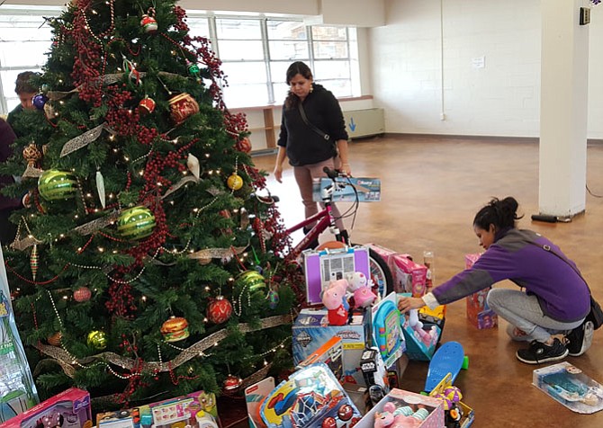 Charitable activities, such as this toy drive by Interfaith Works, can improve one’s overall well-being.