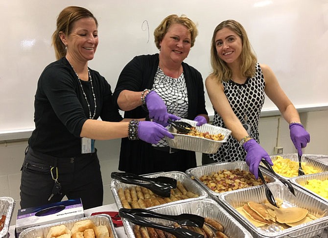 Dishing up hash browns, sausage, pancakes and scrambled eggs are (from left) FCPS career and transition service specialists Sarah Blake, Sue Eaton and Maggie Contreras.