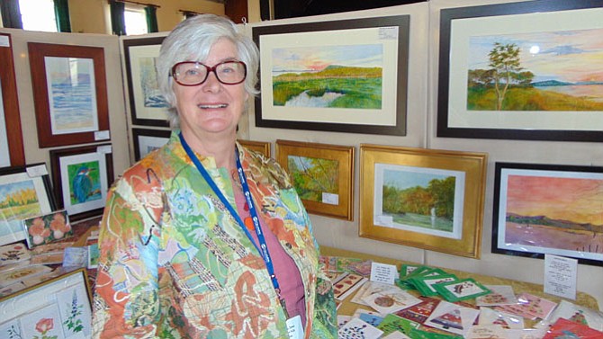 Linda Jones, president of Great Falls Studios, with her watercolors and mixed media paintings. 