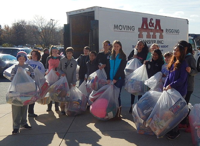 Stone Middle School students prepare to load donated gifts into a truck headed for ONC’s warehouse after last year’s Panther Drop-Off. This year’s collection will be Saturday, Dec. 9, from 9 a.m.-noon.