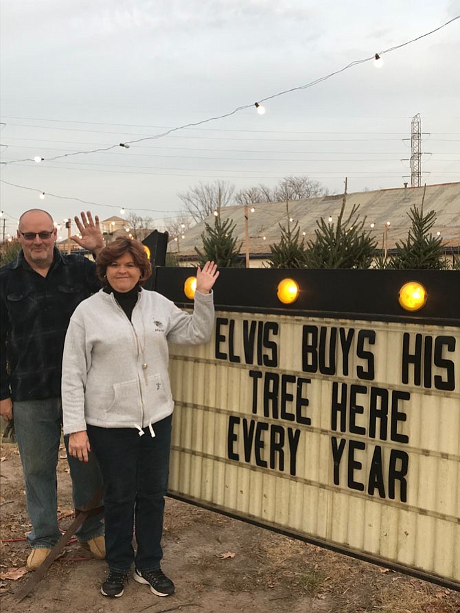 Suzanne Eaton, owner of Suzanne Eaton Christmas Trees and Jim Pettis, assistant, wave a bittersweet goodbye as the days countdown to their final Christmas tree sale date in the Town of Herndon scheduled for Dec. 20, Suzanne and Mark Eaton (not pictured) have sold trees in Herndon for 31 years.