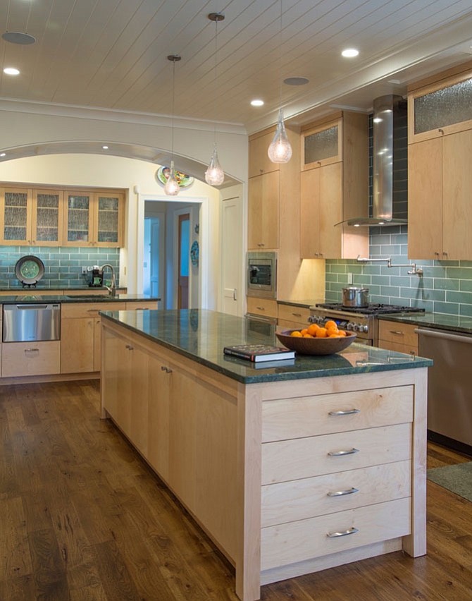 This McLean kitchen by Rill Architects includes maplewood, furniture-style cabinets with brushed nickel hardware, classic millwork and granite countertops.