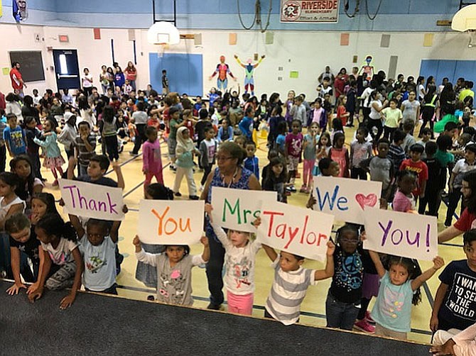 Riverside Elementary students and staff surprise “lunch lady” Dorothy Taylor with a celebration of her 40 years at the school. Full funding of K-12 education is a top priority for the Fairfax County Board of Supervisors.