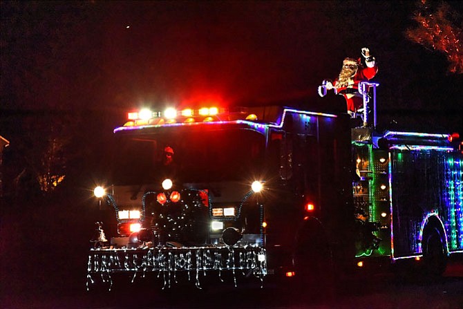Santa rides through Potomac Falls with the help of the Cabin John Park Volunteer Fire Department. Santa’s scheduled nightly run through the area community is 6-9 p.m. through Dec. 20. He is also accepting presents for children that CJPVFD members will donate to the National Center for Children and Families and the United States Marine Corps Toys for Tots program. New toys may be brought out to Santa as he passes by on the fire truck or dropped off at either Cabin John Park Fire Station 10, 8001 River Road or Station 30, 9404 Falls Road. See www.cjpvfd.org.