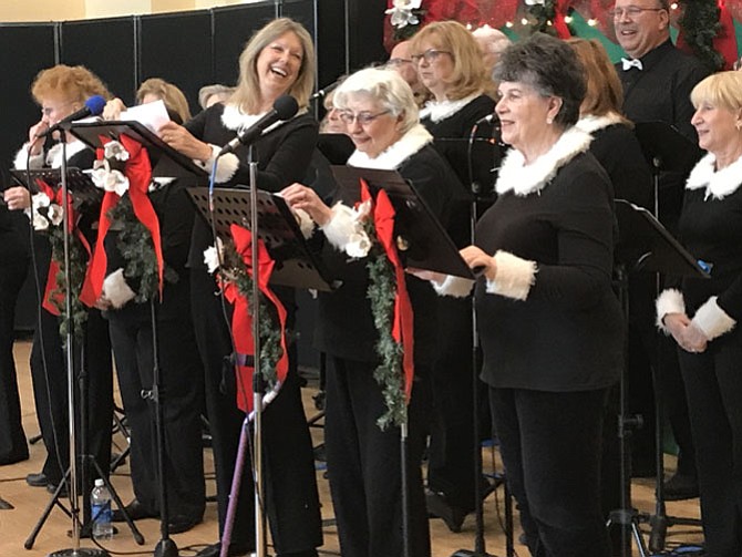 Members of the Sun Dance Singers directed by "C" Culpepper enthusiastically ring in the Christmas season performing a medley of classic holiday favorites during their concert gift to members of local Fairfax County Senior Centers. 