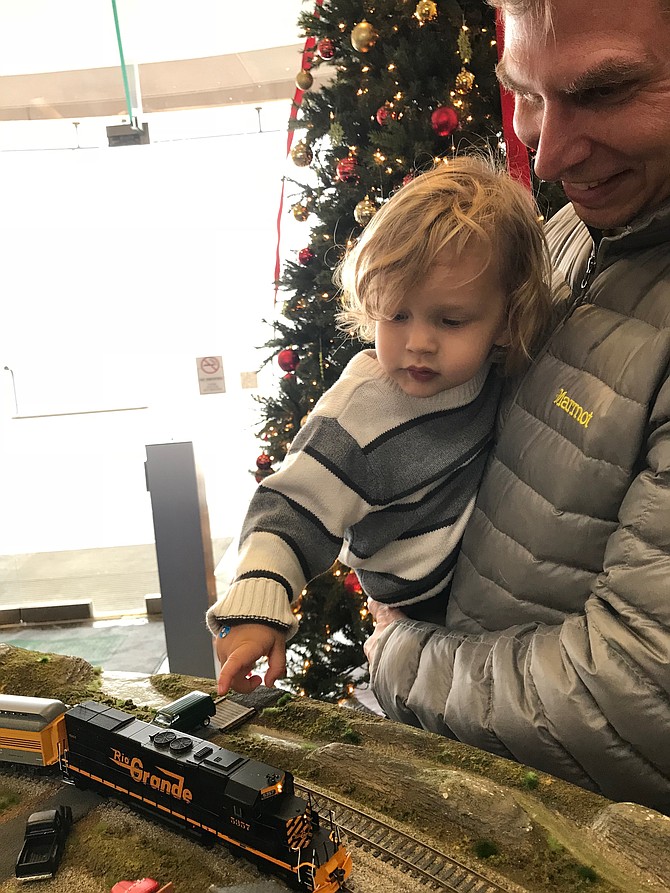 Two-year-old Simon Baker cannot believe his eyes. The best thing in life has come his way, TRAINS. According to Nathan Baker, Simon's uncle, the toddler's first words when he spoke were "choo, choo."