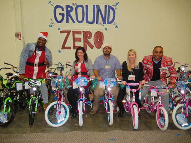 Volunteers posing with some of the bicycles to be gifted are (from left) Ralph Harmon and Sarah George, both with Metronome government contractors, and Arjun Suryakant, Kristi Liesegang, and Ron Richmond, all with Splunk software sales. 