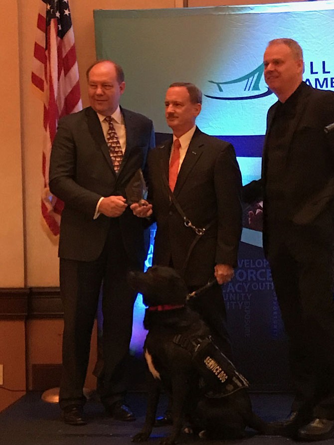 James Kuiken, Kuiken Group of Vienna (center) accepts the Distinguished Veteran award from John Boylan, President and CEO, Dulles Regional Chamber of Commerce while James Lawson, Chairman, Board of Directors, Dulles Regional Chamber of Commerce looks on. "I do what I do for those who did not make it home, physically, psychologically or emotionally," said Kuiken to the audience after accepting the award.