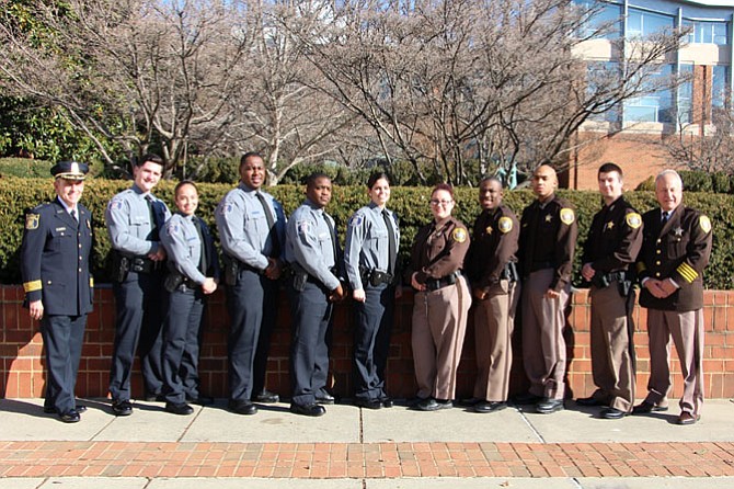 Nine new Alexandria law enforcement officers – five police officers and four deputy sheriffs – graduated from the Northern Virginia Criminal Justice Training Academy on Dec. 19. Sheriff Dana Lawhorne, Police Chief Michael L. Brown, and members of their command and training staffs attended Session 137’s graduation ceremony at George Mason University. From left are Chief Michael L. Brown, Officer Francisco San Miguel, Officer Gladys Corea, Officer Marcus Morsell, Officer Otis Jackson, Officer Emily Plisco, Deputy Kelly Allen, Deputy Lamar Gayle, Deputy Joshua Barnes, Deputy Sean Scalsky, and Sheriff Dana Lawhorne.