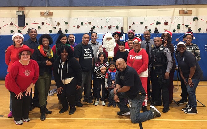 First responders from across the city gather for a photo Dec. 23 at Samuel Tucker Elementary School after distributing more than 800 toys to children and families in need.