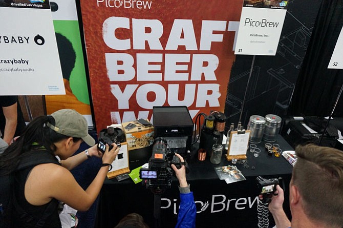Members of the media get a closer look at the home brewing design of Pico Brew Jan. 7 at CES Unveiled in Las Vegas.
