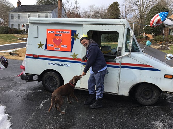 Letter carrier Christopher Bucy pauses by his mail truck, decorated in honor of his last day on the job. Bucy retired Dec. 30 after 31 years of service, 17 as carrier in the McAuley Park neighborhood of Potomac.