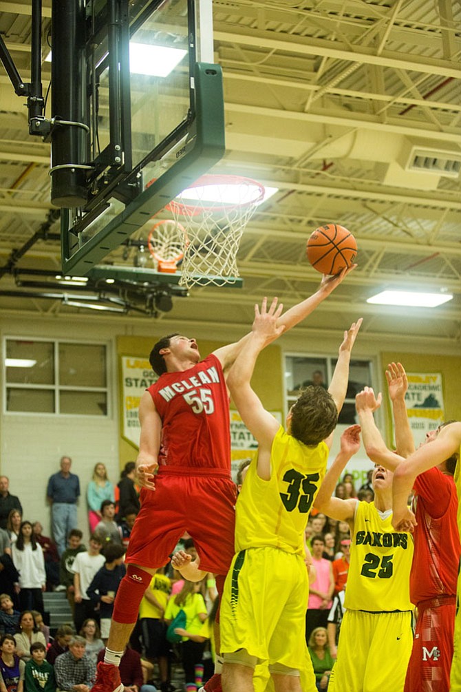 McLean Highlanders forward, Andrew Hale #55, junior, goes for a rebound against Langley Saxon defenders Friday night in a rivalry game at Langley High School.