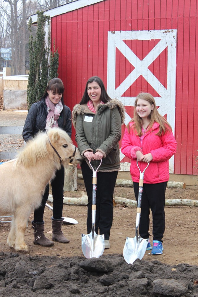 Blythe Champion and Leah Martin, riders at The Northern Virginia Therapeutic Riding Program, with shovels at the groundbreaking ceremony last Wednesday, Jan. 10.