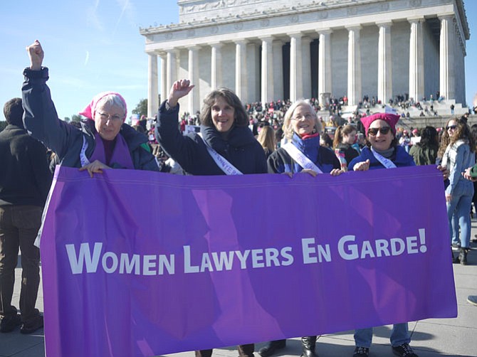 From left: Arlingtonians Lori Masters, Cory Amron, and Diane Greenlee (with Sue Willson Brooks) hold the banner for Women Lawyers on Guard. Women Lawyers on Guard is a non-profit started in January 2017 by matching their network of (mostly, but not exclusively) lawyers with the diverse legal needs of other organizations, assisting nonprofits who have similar missions. 