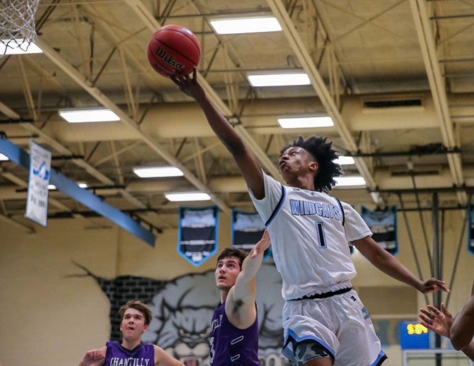 Bryce Douglas #1 rolls the ball off his fingertips for two points in his team's loss against Chantilly.