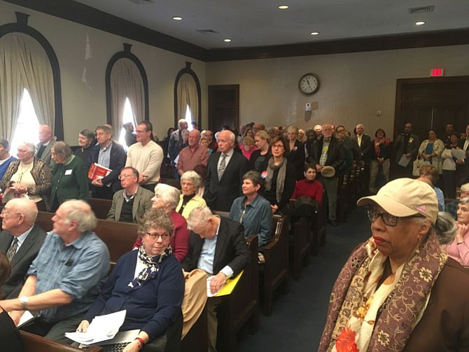 Advocates in favor of the Episcopal Church of the Resurrection’s proposed West End affordable housing project stand in support at a City Council public hearing on Saturday, Jan. 20. Many wore Housing Alexandria and VOICE buttons, two coalitions representing an array of community organizations.