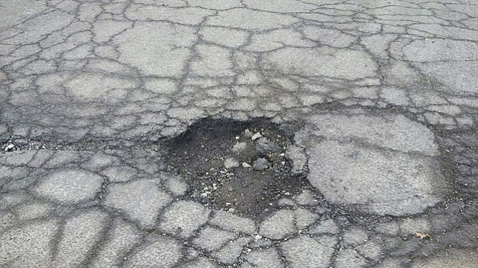 A pothole in the 900 block of Wolfe Street near the driveway of Heritage At Old Town.