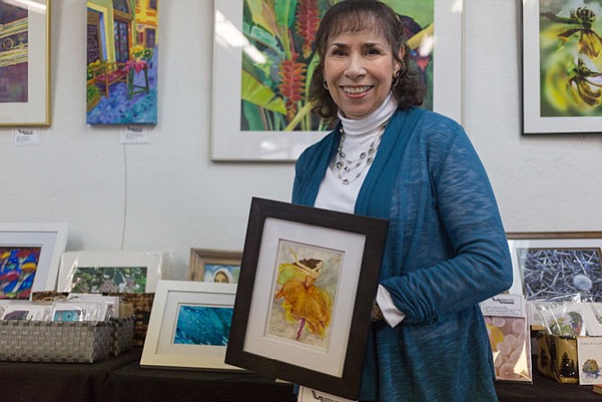 Local artist Joyce Myers, a Vienna resident and a physical therapist, pictured with one of her watercolors on display at Vienna Arts Society’s Jazz It Up show Saturday, Jan. 27.