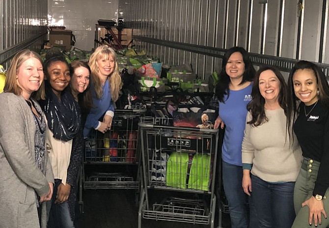 Volunteers from Northwest Federal Credit Union filled 600 bags of food for people to purchase and donate to WFCM’s food pantry. (WFCM’S Jennie Bush is second from right).