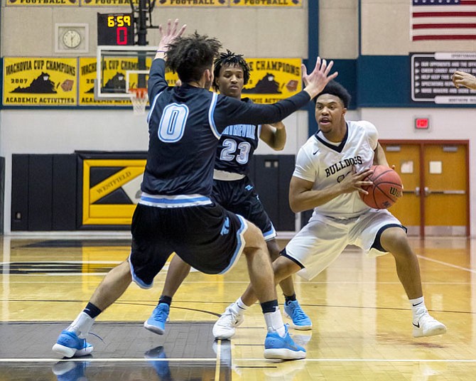 DJ Gregory #10 drives while being defended by #0 Ahmed Ghousheh and #23 Jordan Porter.