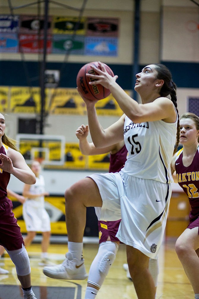 Wanna Wardak #15 takes to the air after getting by Oakton defenders.