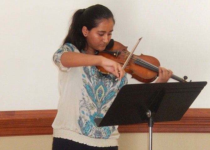 Mahika Ghaisas, with the American Youth Philharmonic Orchestra, plays the violin during the library’s anniversary event.