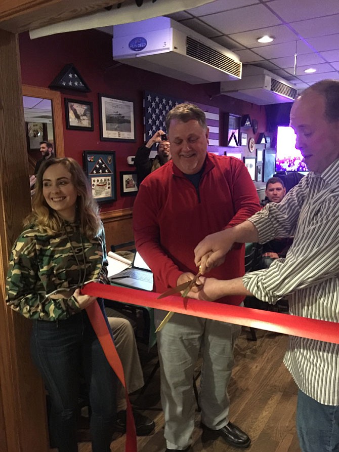 Mike O'Meara, podcast personality and the host of The Mike O'Meara Show cuts the ceremonial ribbon to the entrance of the Beer Garden, a much awaited part of Jimmy’s Old Town Tavern's expansion product.