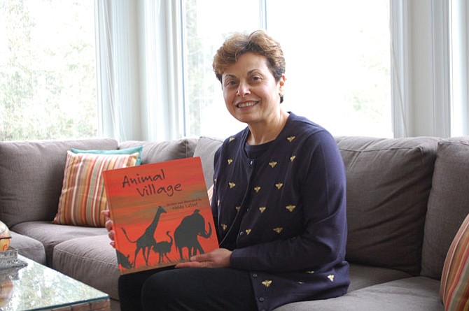 Nelda LaTeef presents her first piece of artwork which happens to be the cover of her newest children's book, “Animal Village.”