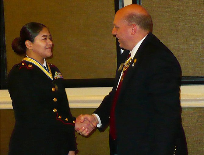 Virginia Society of the Sons of the American Revolution President Michael Elston congratulates Cadet Reyes.