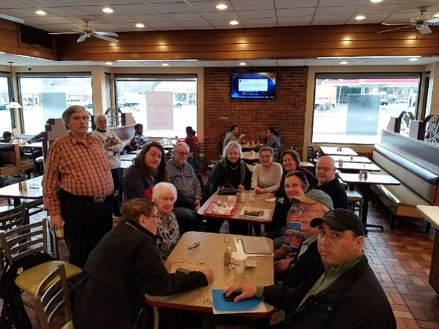 Dealers meet with owner Sam Nasafi (first on the right) to discuss future plans for the antique center.