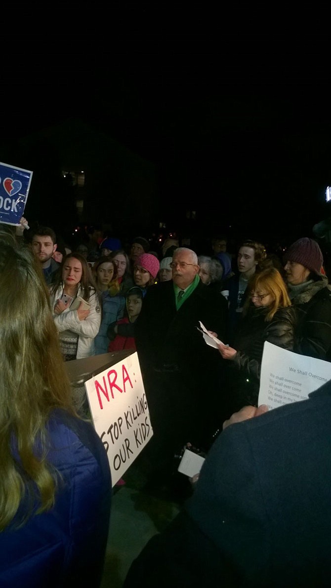 “We are not afraid,” is the phrase U.S. Rep. Gerry Connolly (D-11) sings Feb. 16 with other participants. The group closed a candlelight vigil with Civil Rights anthem “We Shall Overcome” in front of the National Rifle Association headquarters in Fairfax. 