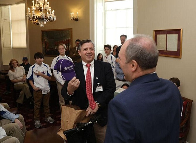 Coach Pete Mensinger presents U.S. Rep. Steve Scalise with an Alexandria Little League baseball hat — courtesy of Darrell Wilson. 