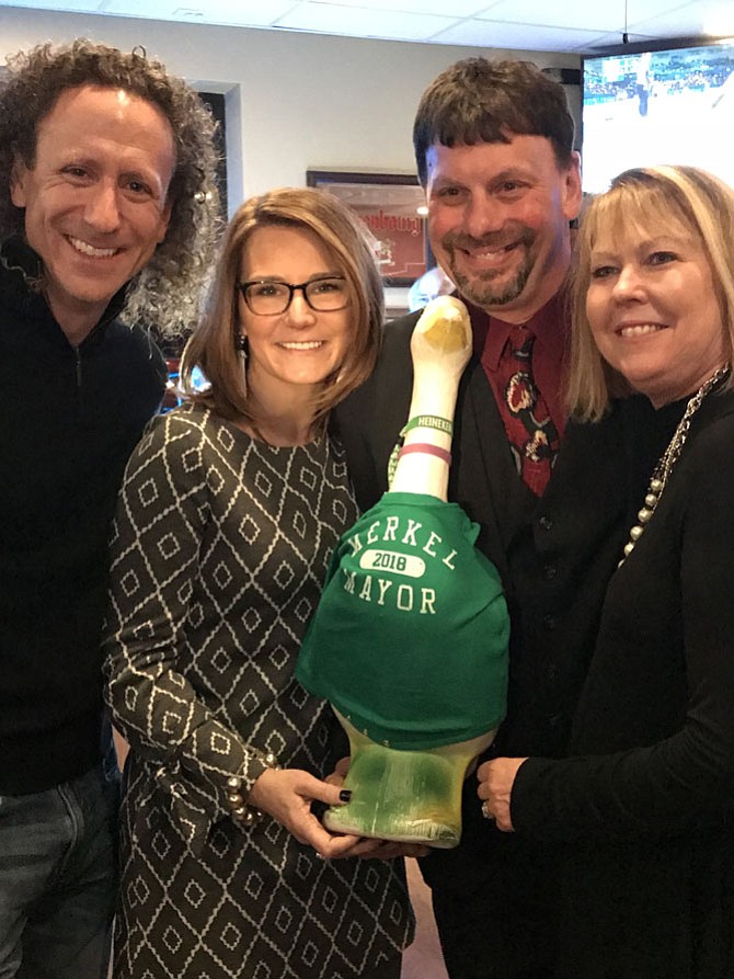 Herndon Mayor Lisa C. Merkel (second from left) announces her intention to seek her fourth consecutive term for the office of Mayor of the Town of Herndon during the Jimmy's Old Town Tavern Mayor’s Opening Reception, held by Jimmy Cirrito and his wife, Maureen (far right). Merkel is accompanied by her husband, David (left).