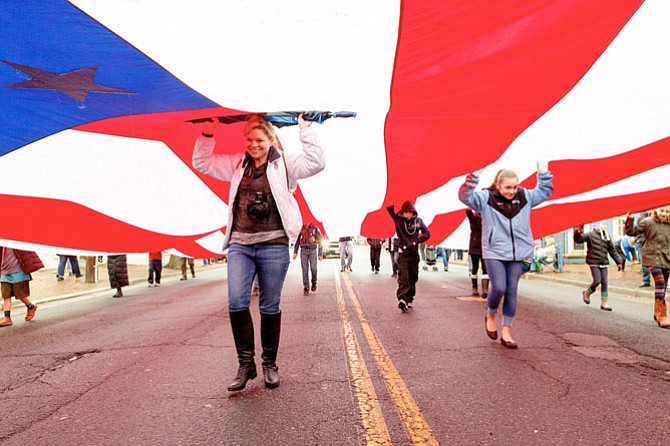 Volunteers carry the Spirit of Liberty flag through the streets of Old Town for the Feb. 19 George Washington Birthday Parade.