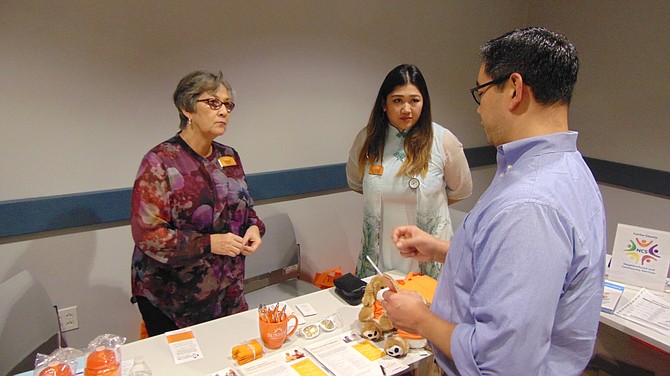 Debbie Mitchell and Hannah Pineda of Sunrise of McLean talk with Juan Tuason.