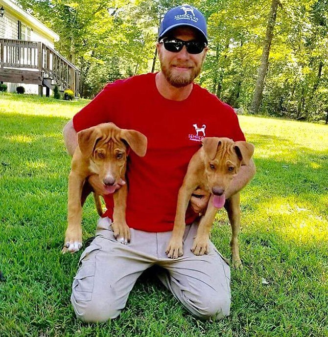 Adoption day for Pete and Duff aka Alvin and Theodore. They are held by Chris Baity, the founder of Semper K9.