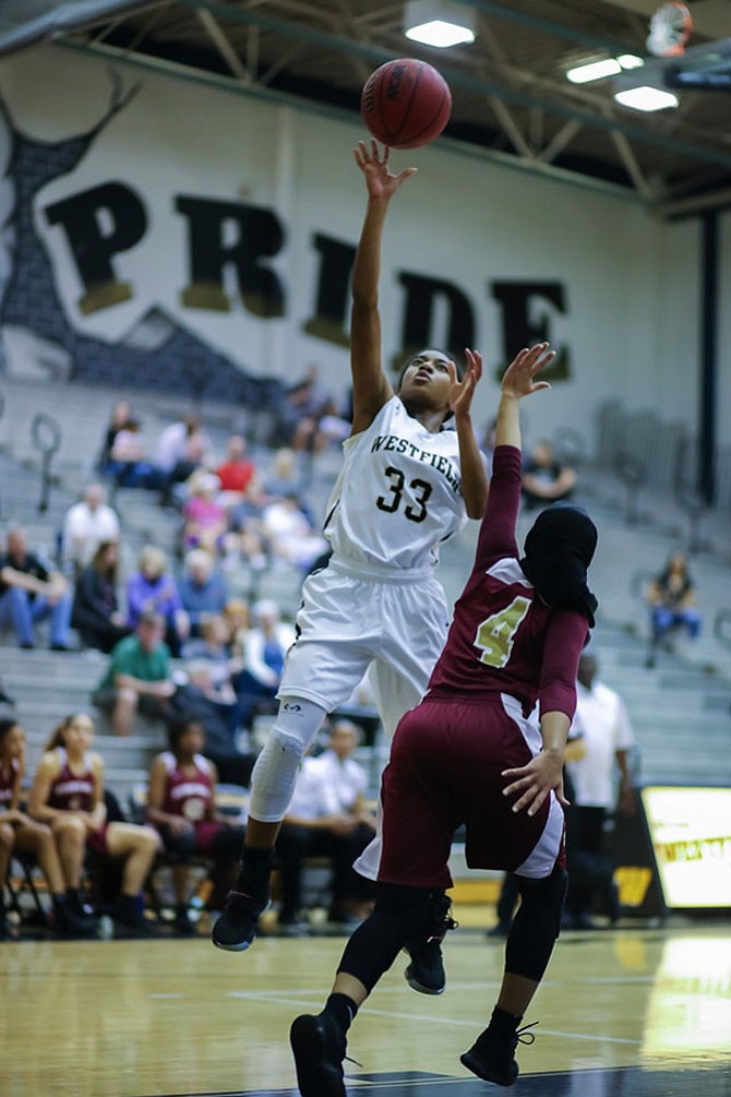 Hannah Williams #33 releases the ball with Maryan Yusef #4 defending.