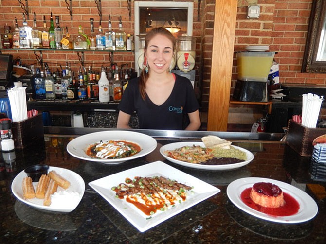 Head bartender Dani Issing with some of Coyote Grille’s offerings (back row, from left) Veggie Chili Relleno and Steak Rajas with beans and rice, and (front row, from left) Churros with Ibarria Chocolate Sauce, Carne con Crema de Maiz, and Sweet Potato Flan with fresh berry compote.
