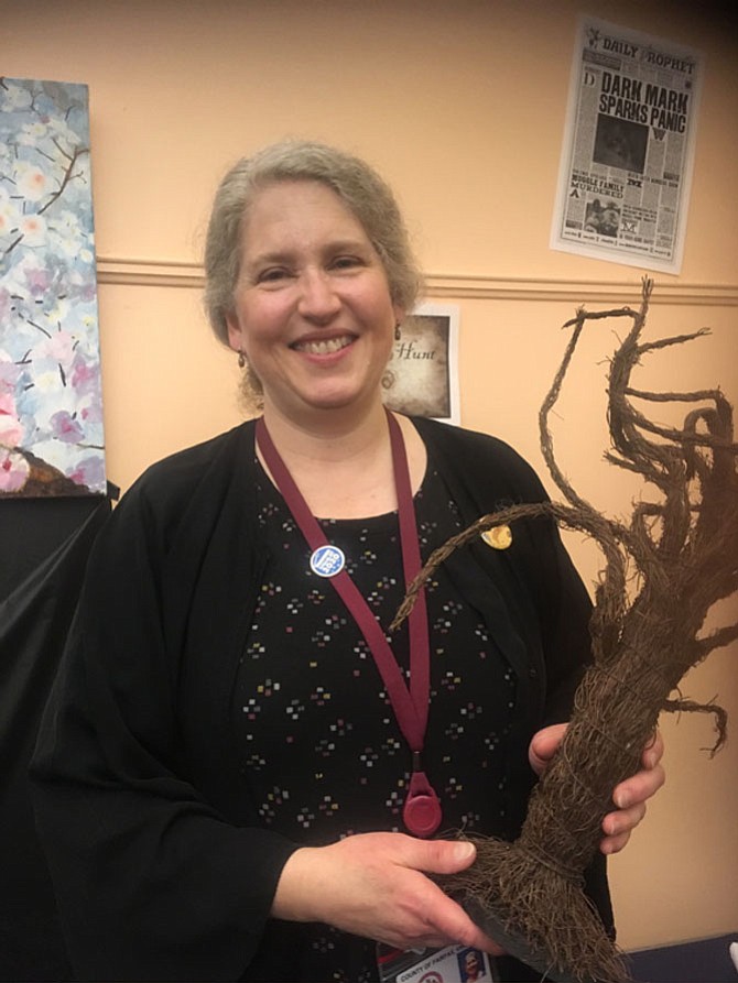 Library aide Laura Damian with a Harry Potter tree at the Kings Park Library in Burke.