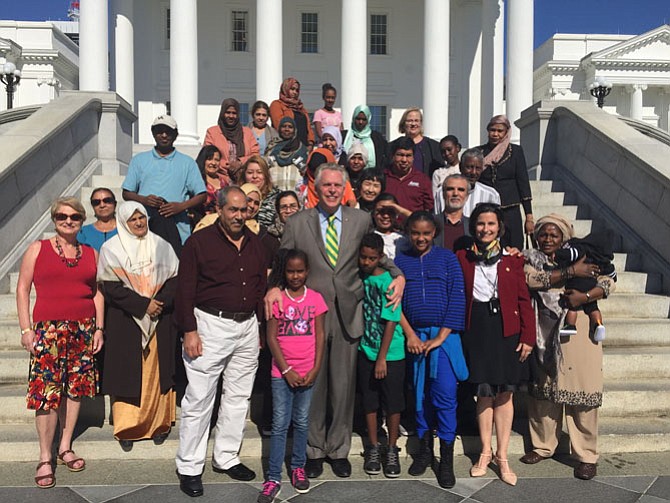 Virginia Governor Terry McAuliffe (center) and Del. Jennifer B.  Boysko (D-86), second from right, welcome Gillian Sescoe, teacher, Cornerstones' American Citizenship class  (far left) and her students to the Virginia State Capitol Building in Richmond. 
