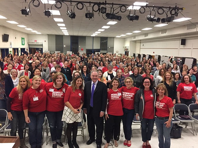 Sen. Tim Kaine (center) spoke at the Moms Demand Action meeting at Frost Middle School in Fairfax on Feb. 28, where some 300 people attended.