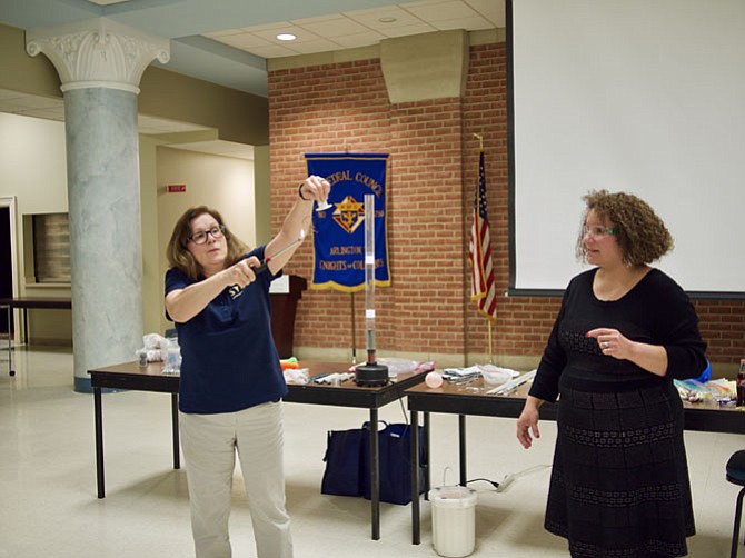 Dr. Angela Moran asks teacher Raylene Rozzi, “You aren’t afraid of fire, are you?” as she straightens out Nitinol with an electric match.