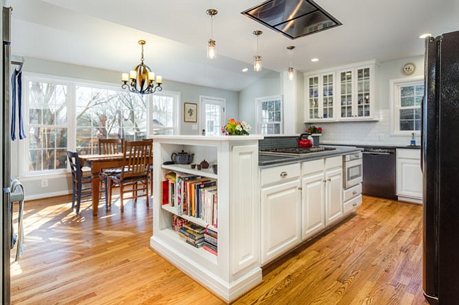 To create the new rear-facing great room, Foster Remodeling Solutions removed a bearing wall separating the existing house from an old sunroom, raised the floor to level with the house and installed oak flooring.
The old porch roof was replaced and tied-off with the roof on the home's main block. The foundation to the former sunroom was reinforced with concrete footings; spray foam insulation assured a seamless, thermally-comfortable interior.