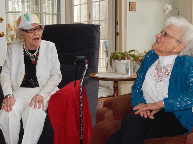 Two centenarians, cousins Mildred DeBell (left) and Iris Vann, sing together.