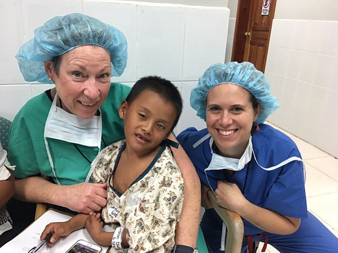 Cristian Goiros, 6, of Honduras is blinded by a white cataract in his left eye. He is about to go into the operating room with Dr. Jordana Fein (right) of The Retina Group of Washington as part of her volunteer service with the Arlington-based Virginia Hospital Medical Brigade.
