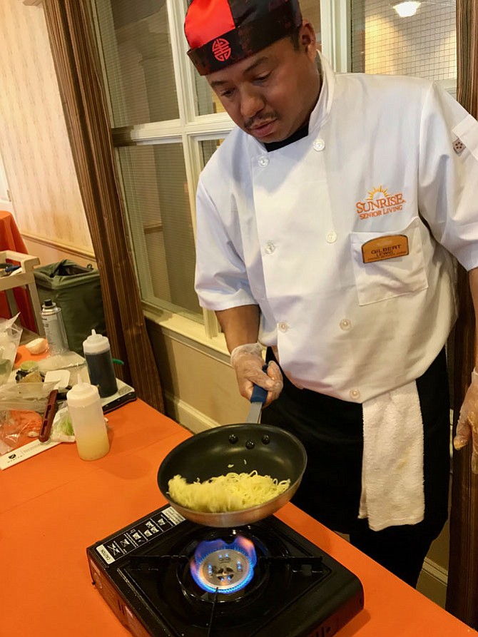 Gilbert Lewis, Chef, Sunrise of Reston readies the secret ingredient, pasta during a fiery battle to the finish at the Second Annual Taste of Sunrise-Iron Chef Competition.