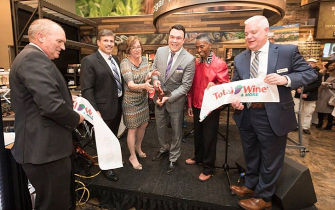 Nicholas Frajo, Store Manager (center) cuts the Ceremonial Ribbon celebrating the opening of Total Wines & More, Reston while employees, guests and Supervisor Cathy Hudgins (D-Hunter Mill) look on.